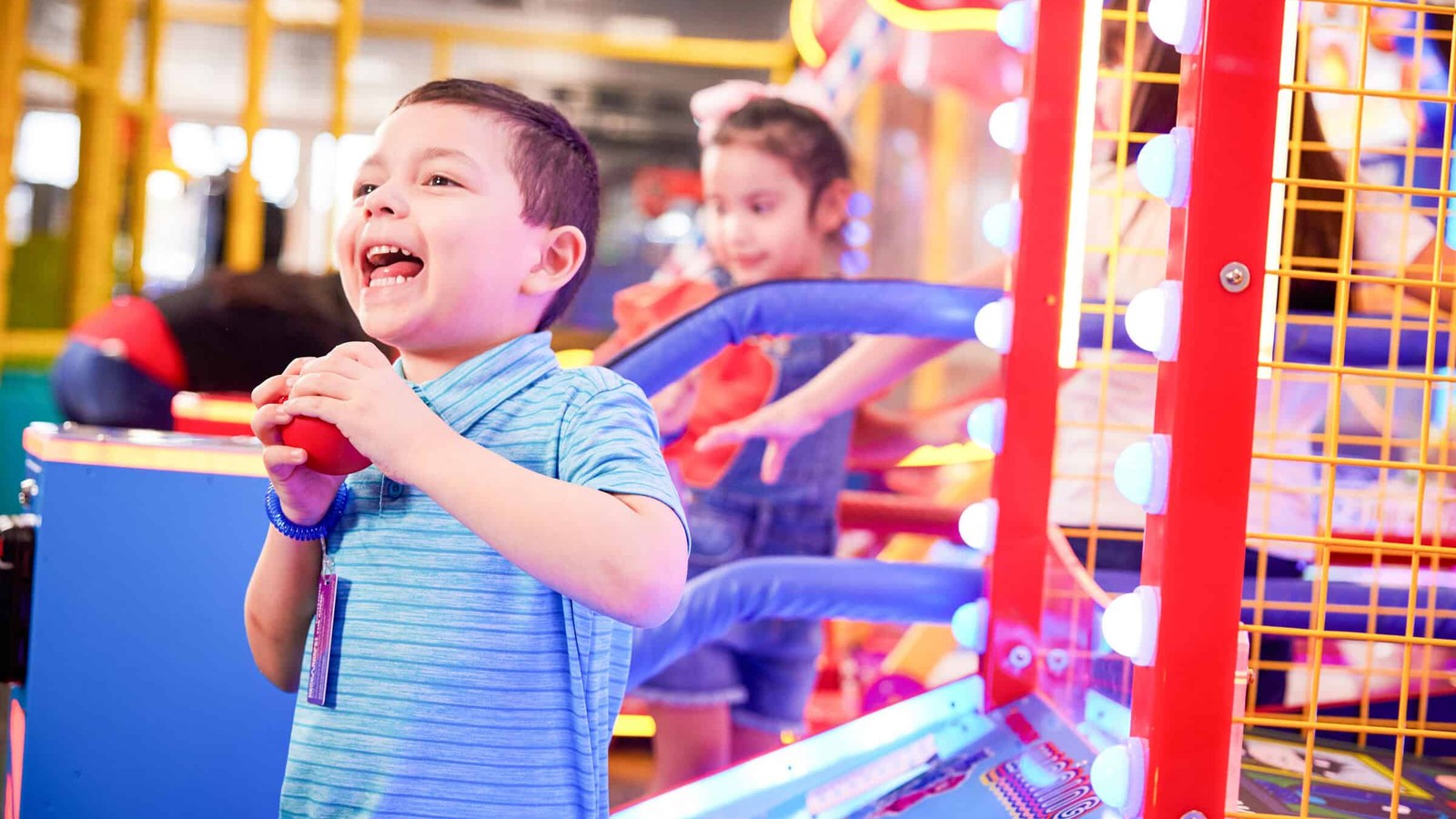 Kids playing arcade games at Chuck E. Cheese Pembroke Pines — remodeled family entertainment center with bright game machines