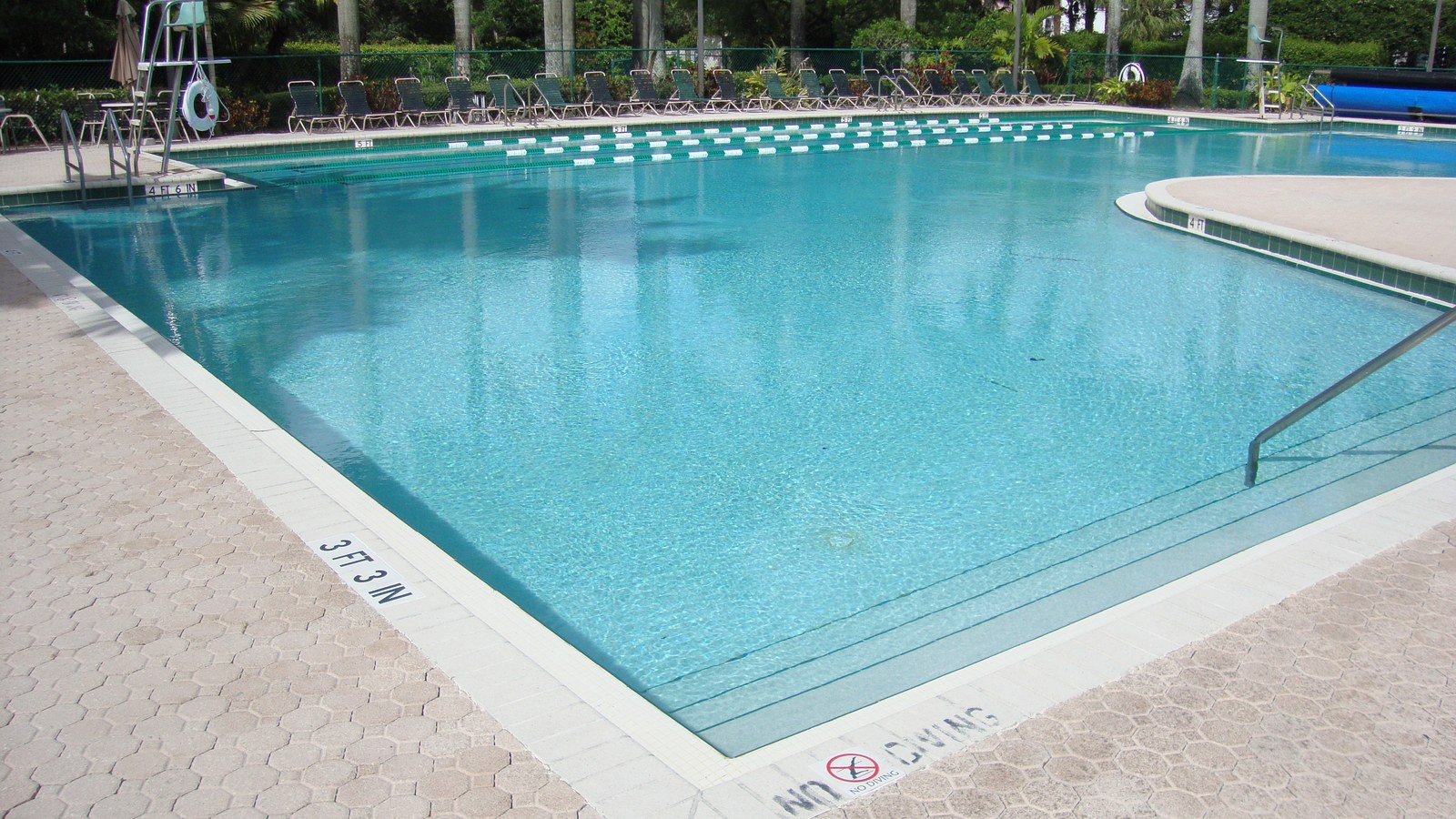 Towngate Park heated swimming pool with bright blue water and lounging area in Pembroke Pines, Florida