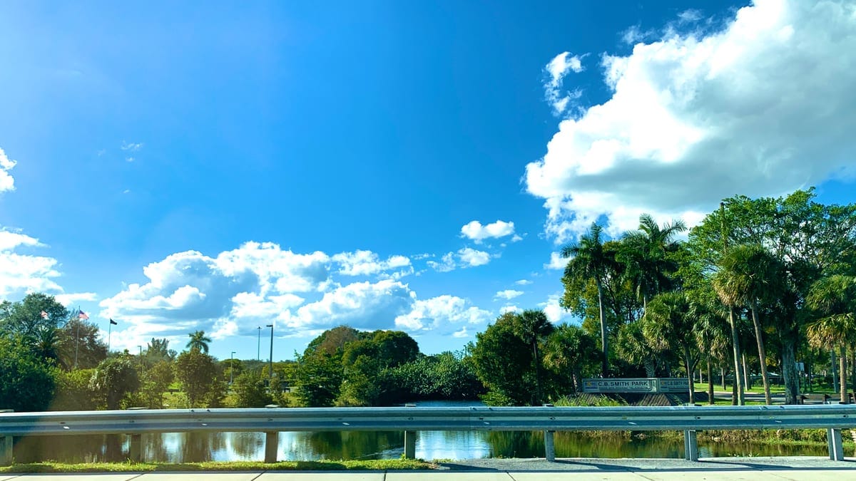 C.B. Smith Park aerial view showing the lake, water park slides, and lush green park grounds in Pembroke Pines, Florida