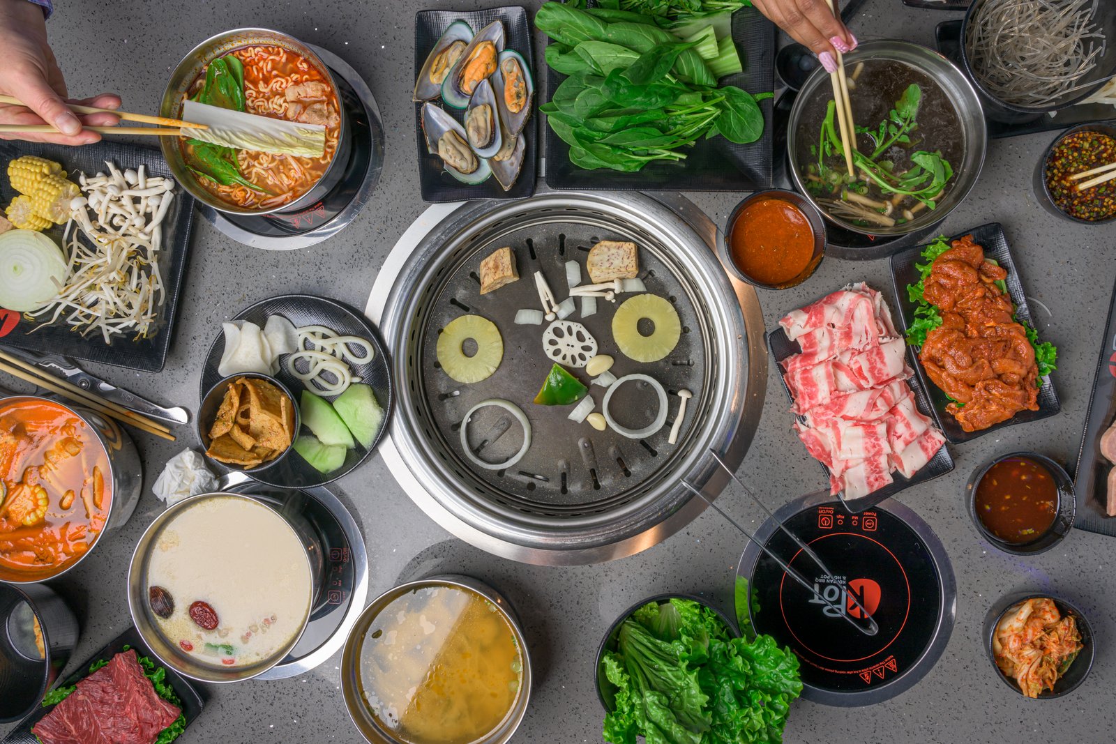 KPOT Korean BBQ & Hot Pot Pembroke Pines — all-you-can-eat Korean BBQ tables with grill and hot pot